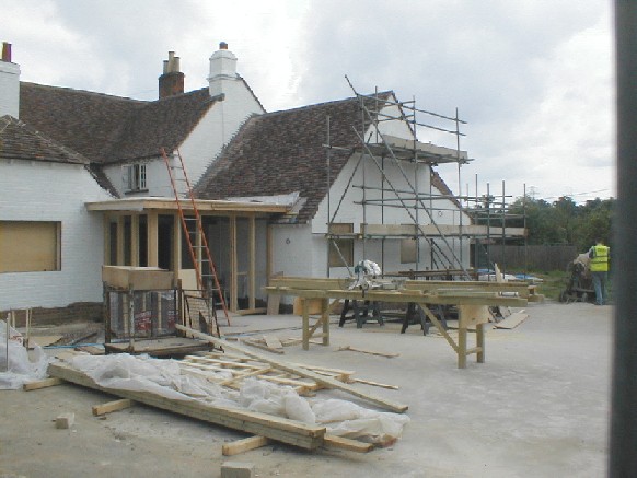 The new extensions both have roof tiles, but the entrance is just a framework