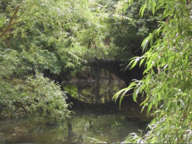 The arch of a brick bridge, connecting the islands between the River Loddon channels.