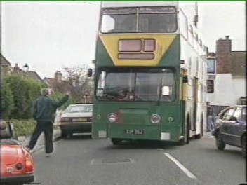 Roger Higgs directs a double-decker bus being driven as part of the 'Road-Block'