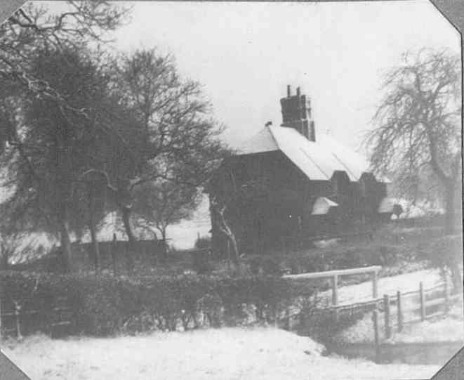 Brook Cottages in the snow, with the ford in the foreground