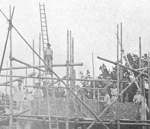 At the top of the partly-completed bell tower