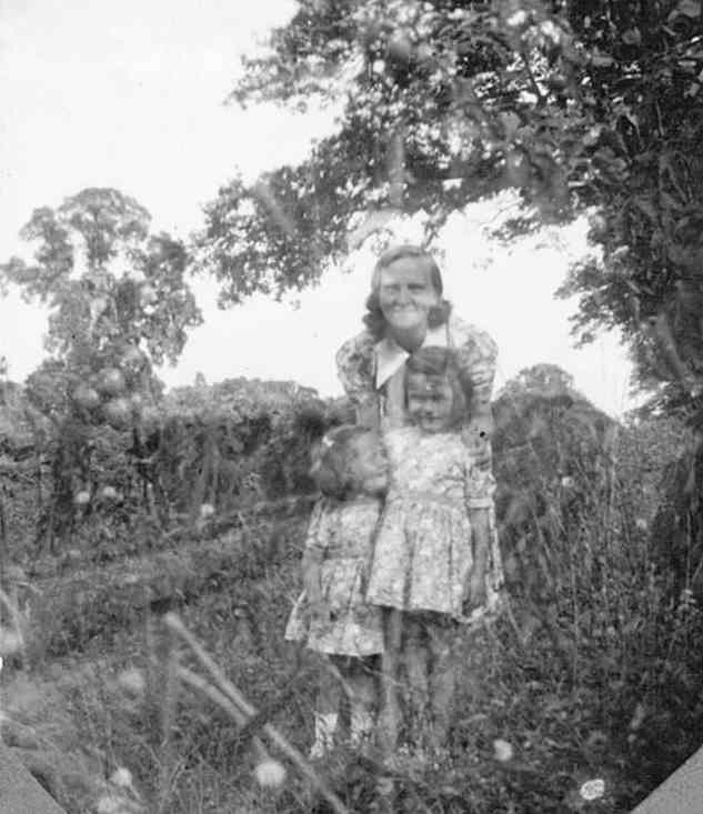 Joyce Slade and her daughters in the garden