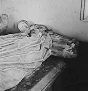 The child, facing towards her parents, in the Standen Tomb at the old church